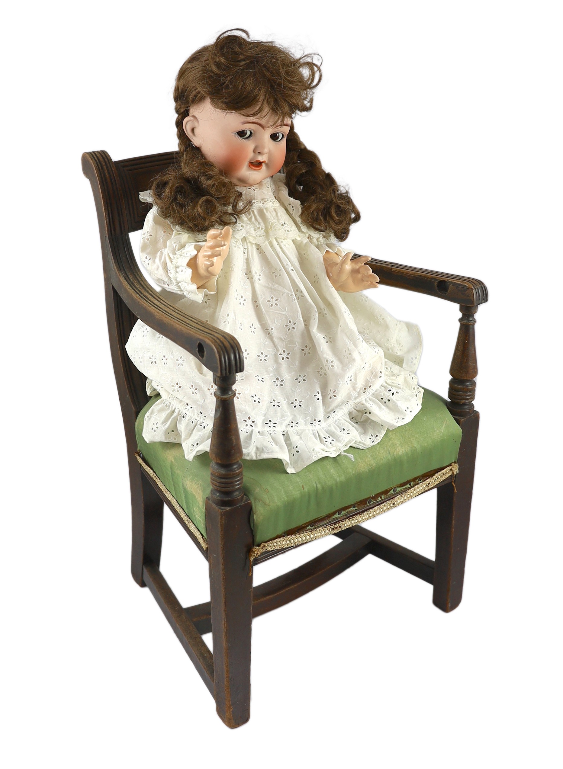 A Kammer & Reinhardt / Simon & Halbig bisque character doll, circa 1914, 22in. Please note the chair is for display purposes only.